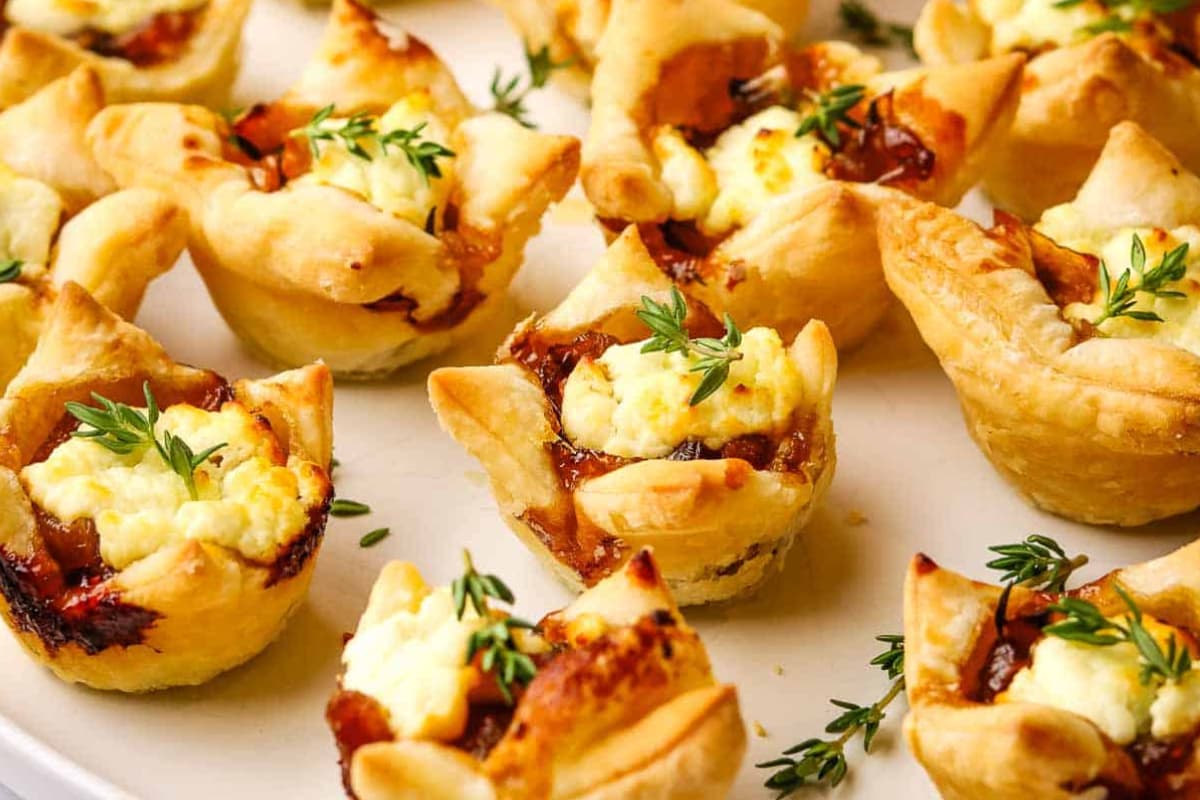 A plate of Caramelized Onion and Goat Cheese Tarts.