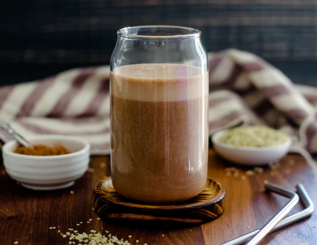 A glass of chocolate hemp milk.
