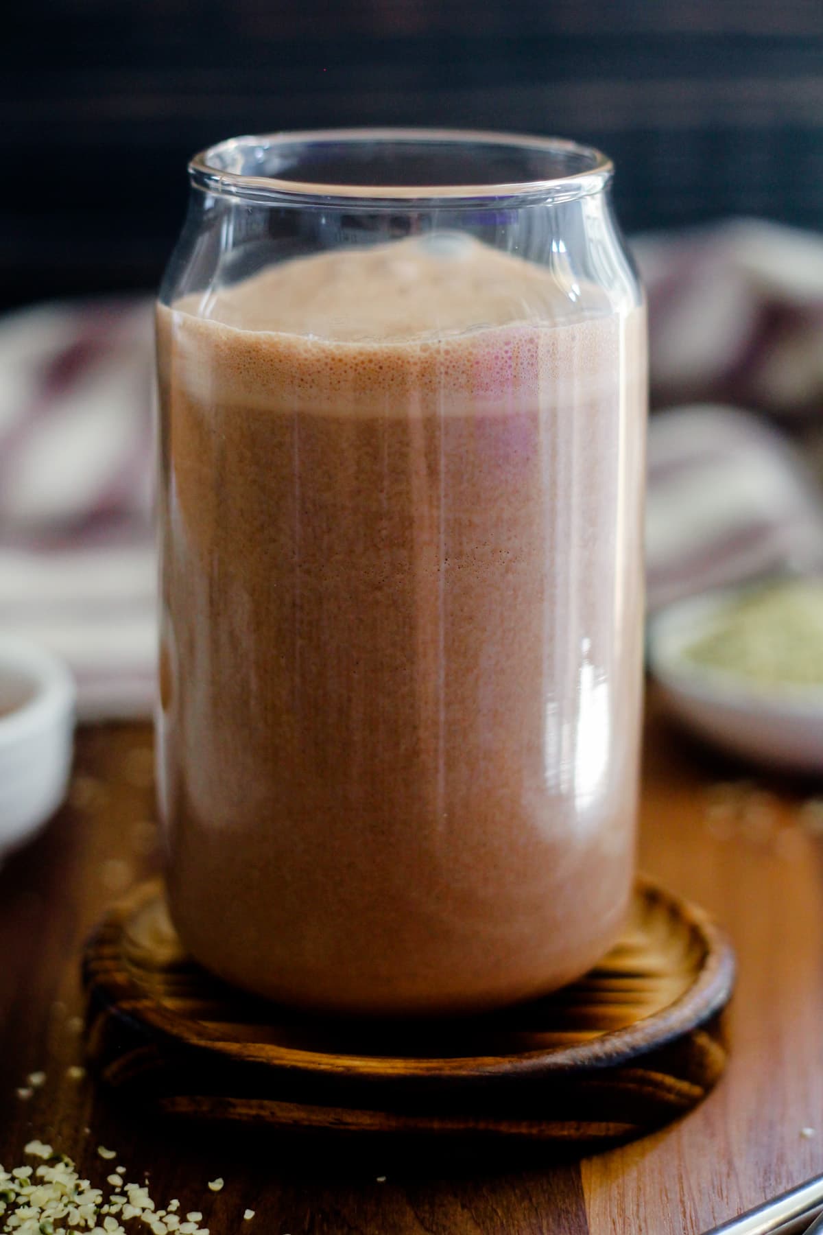 A glass of chocolate hemp milk.