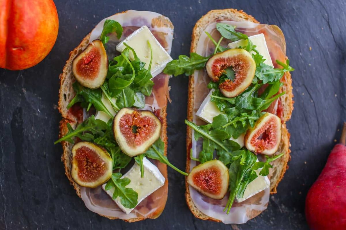 A plate of Fig, Prosciutto and Brie Open-Faced Sandwich.
