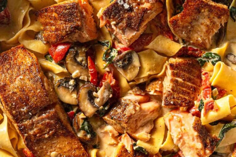 A bowl of Creamy Cajun Salmon Alfredo Pasta.