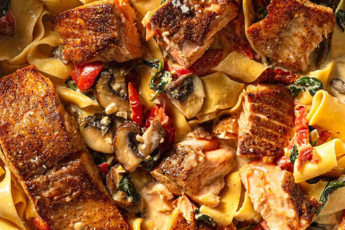 A bowl of Creamy Cajun Salmon Alfredo Pasta.