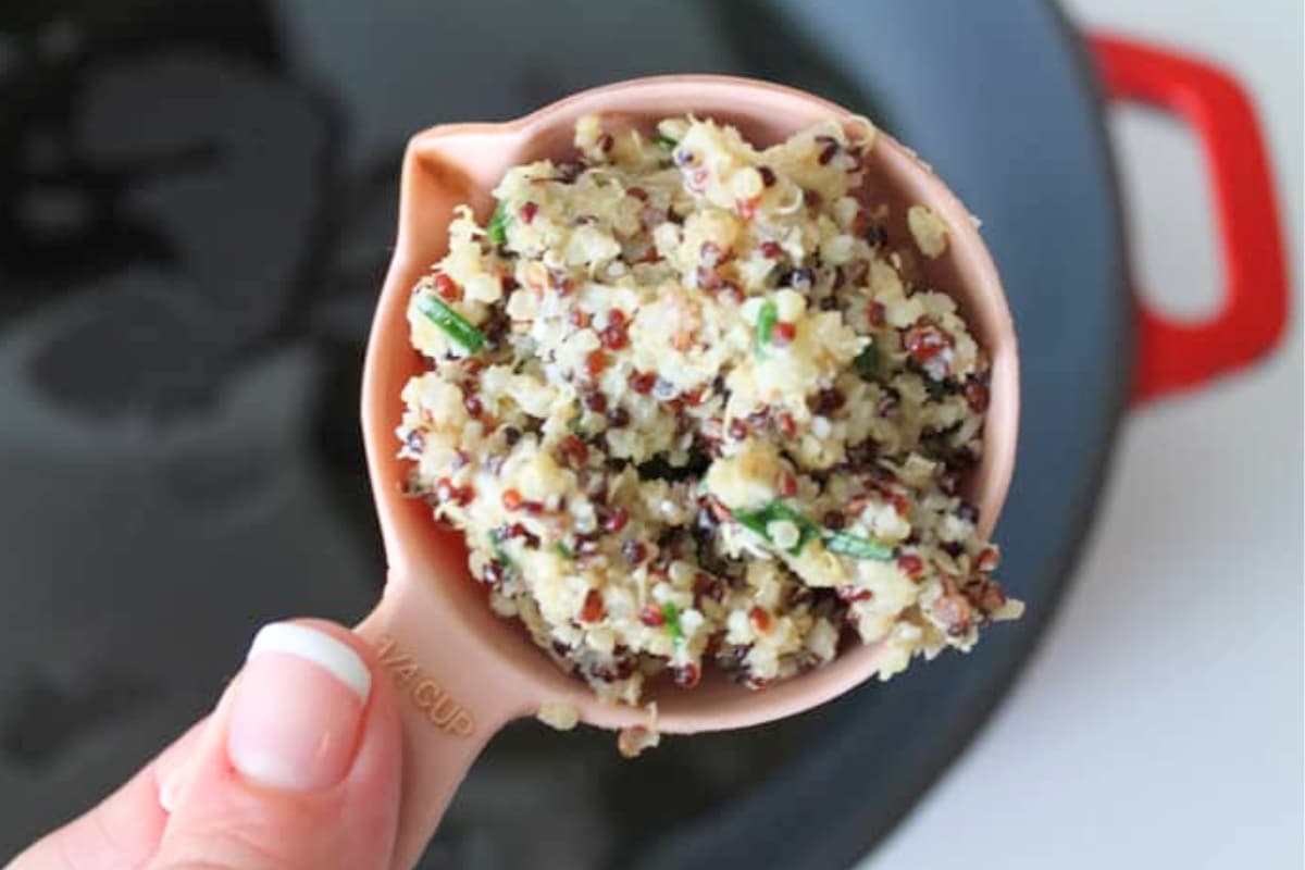 Quinoa mixture in a measuring cup.