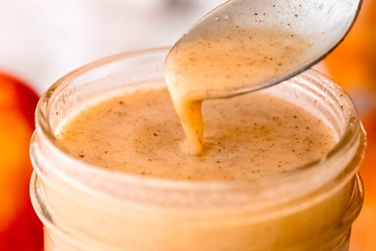 A jar of apple cider vinaigrette dressing.