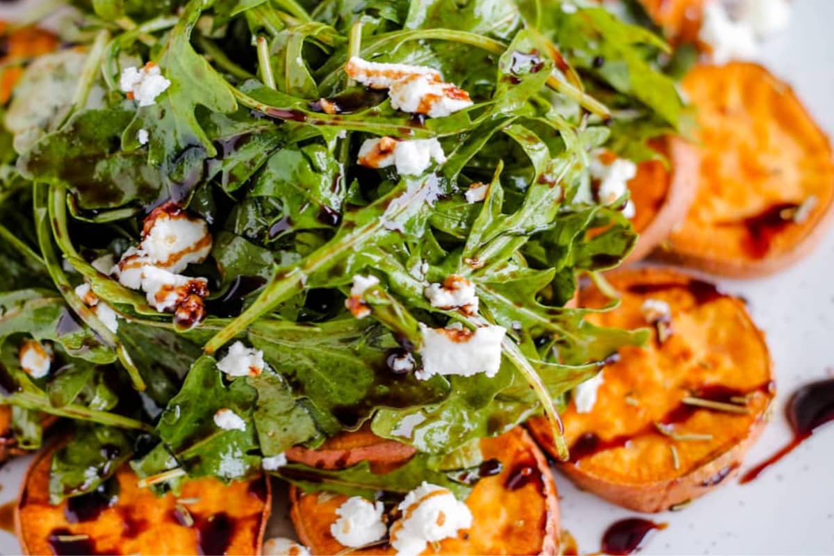 A plate of Arugula and Sweet Potato Salad with Goat Cheese.