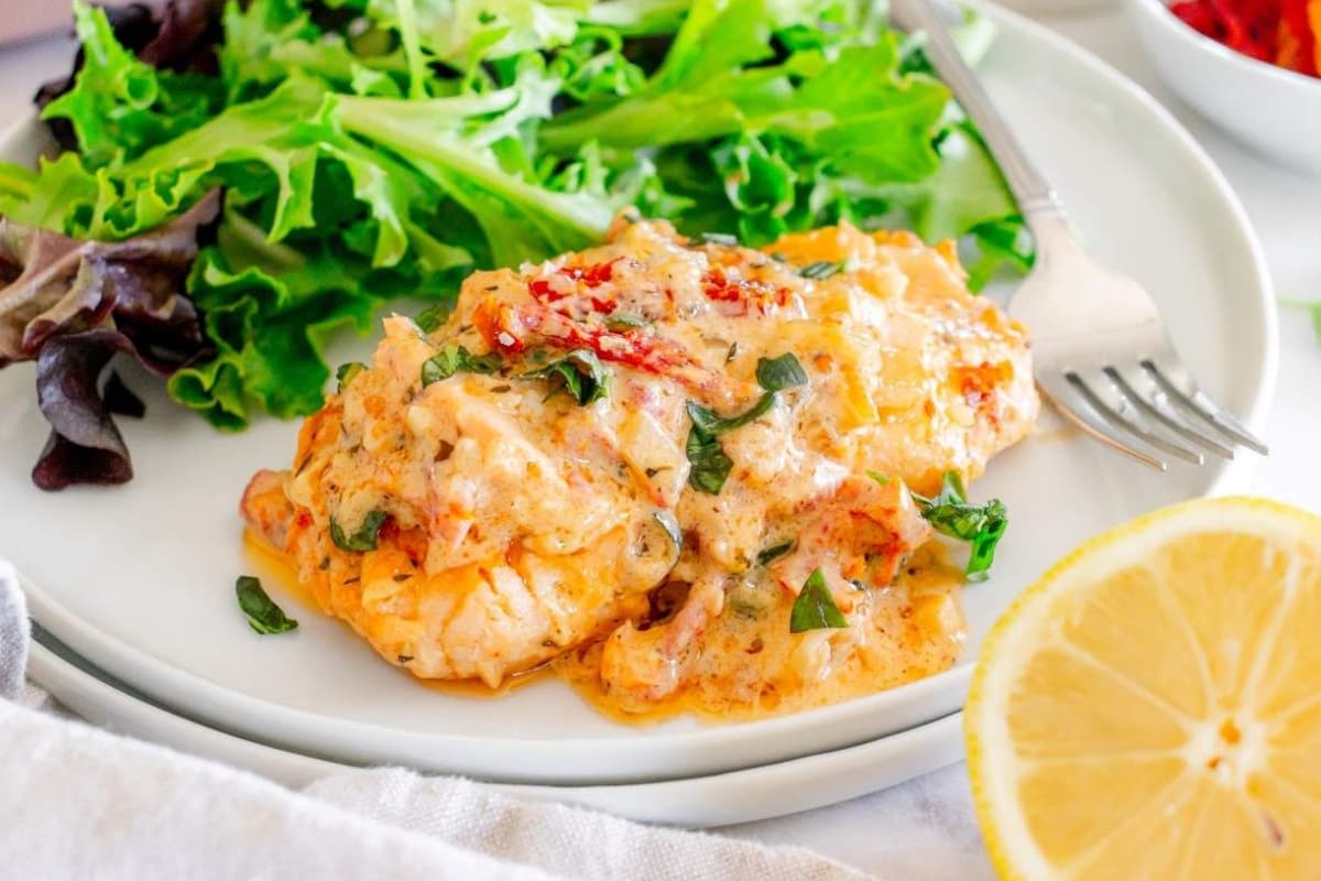 A plate of Creamy Tuscan Marry Me Salmon.