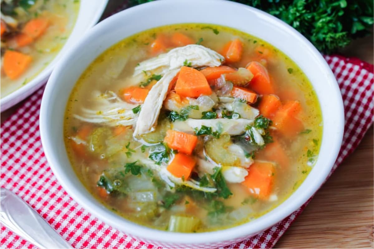 A bowl of chicken vegetable quinoa soup.