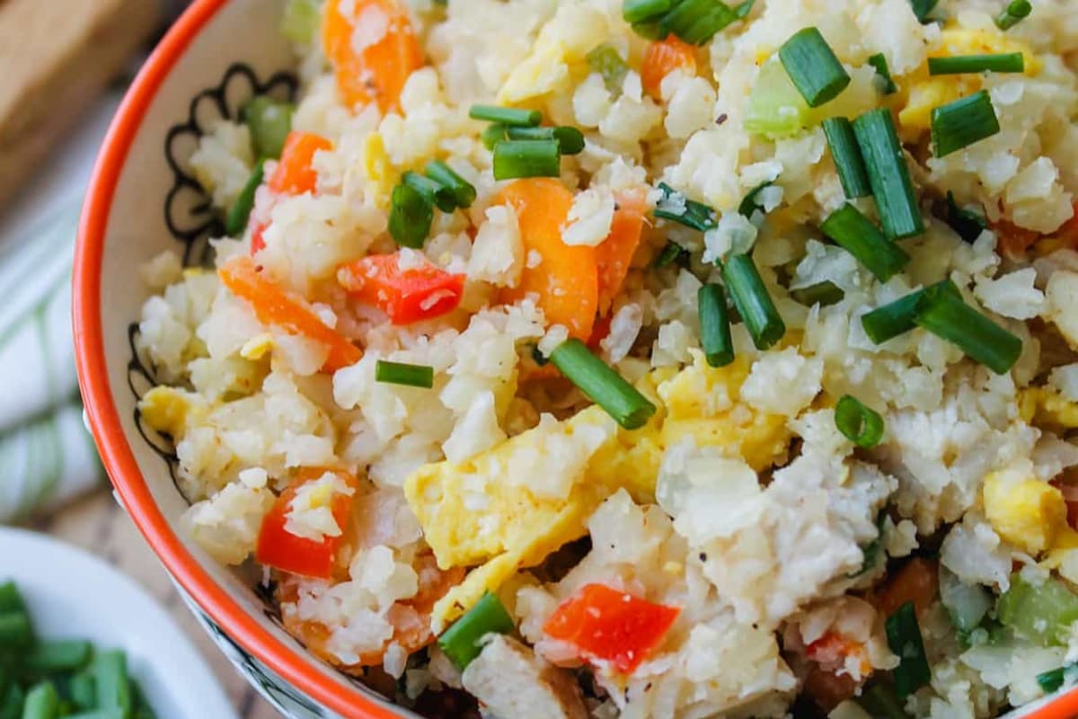 A bowl of High-Protein Chicken Cauliflower Fried Rice.