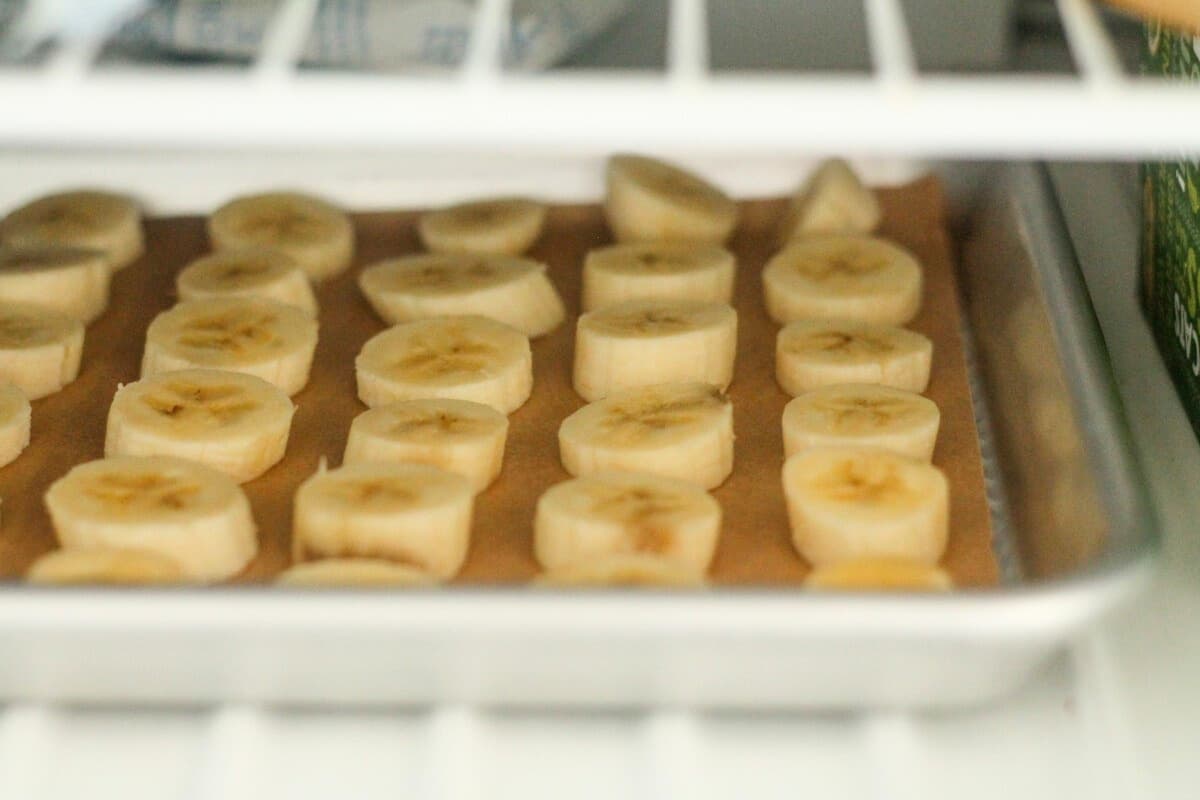 A tray of bananas in the freezer.