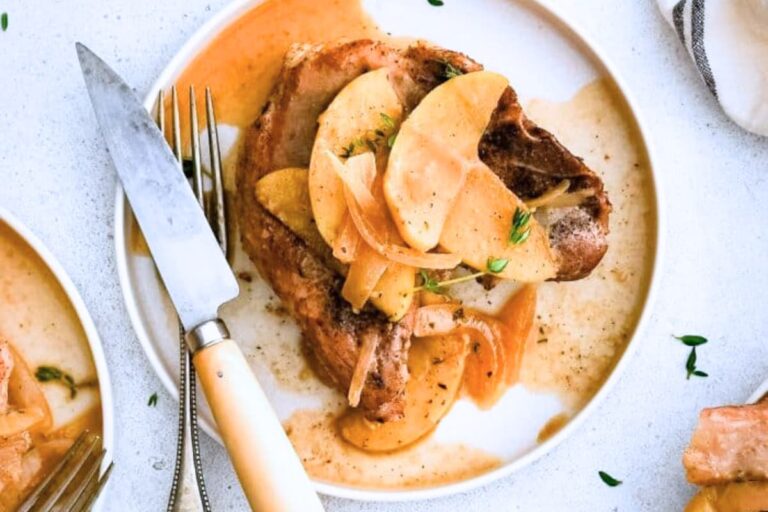 A plate of Pork Chops with Apples and Onions.