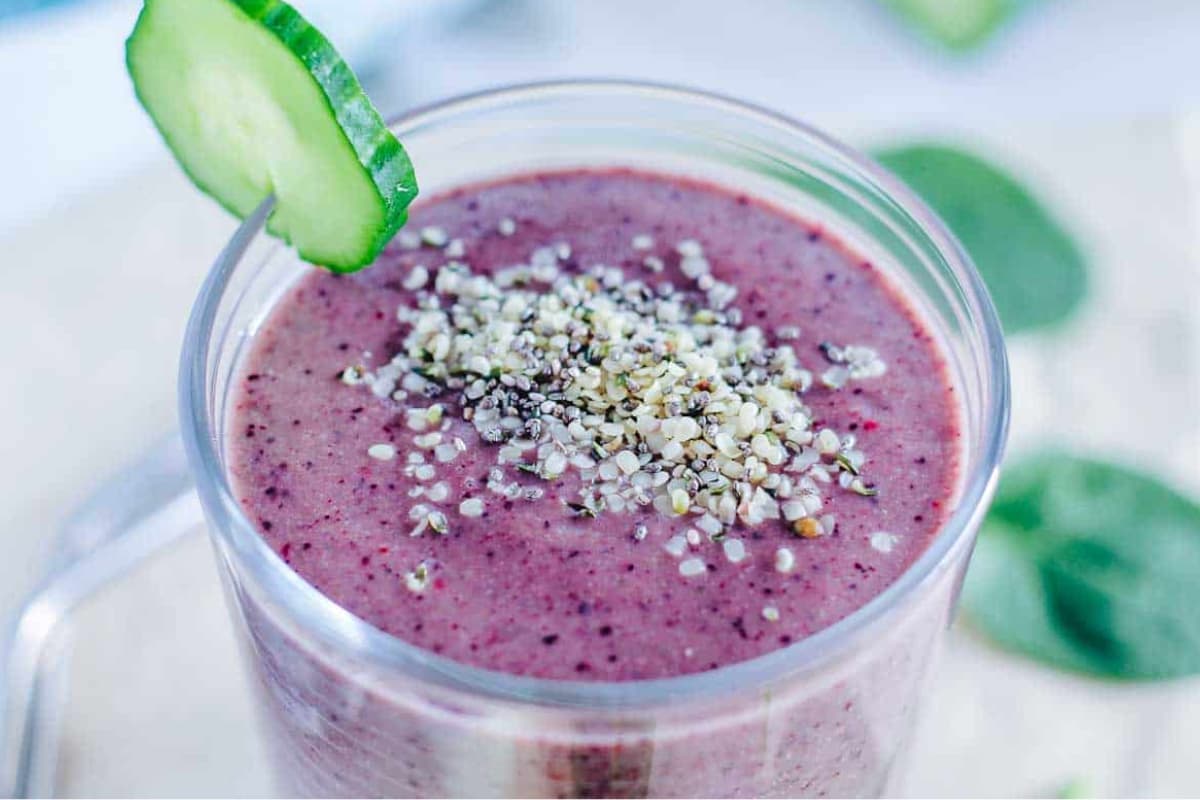 A glass of Blueberry Cucumber Spinach Smoothie.