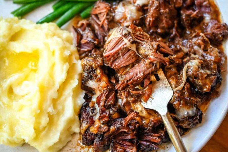 A plate of slow cooker french onion beef pot roast.