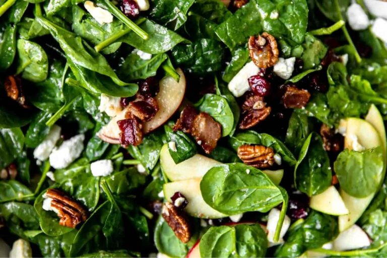 A plate of Spinach Apple Bacon Salad with Maple Dressing.