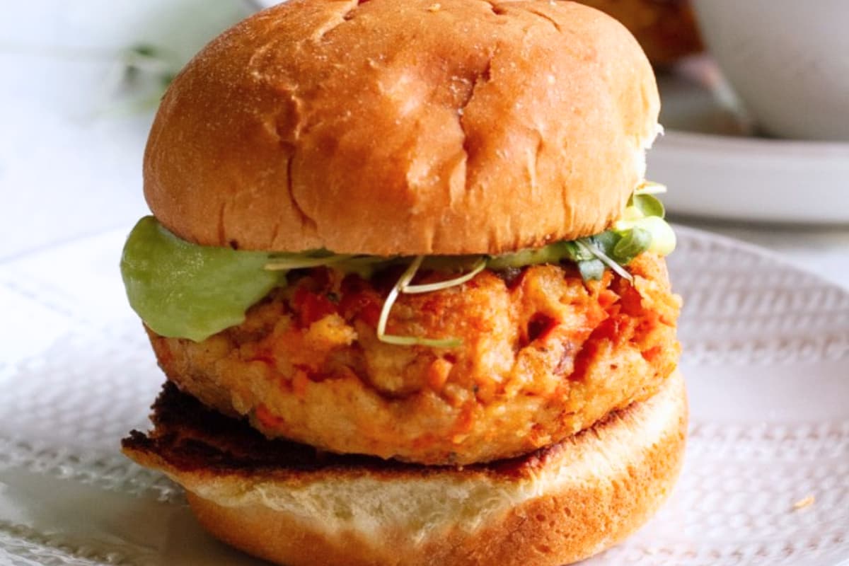 A plate of Salmon Burgers with Avocado Sauce.