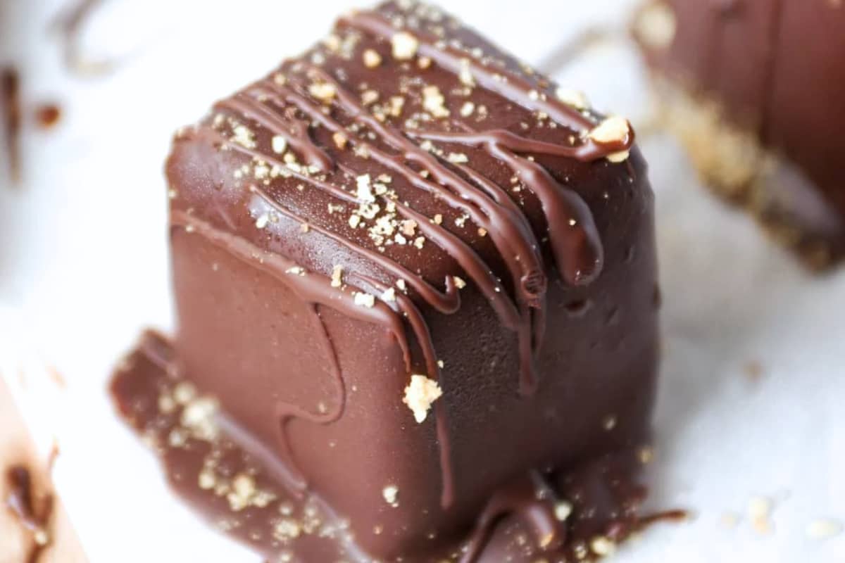A plate of Chocolate Covered Cheesecake Bites.