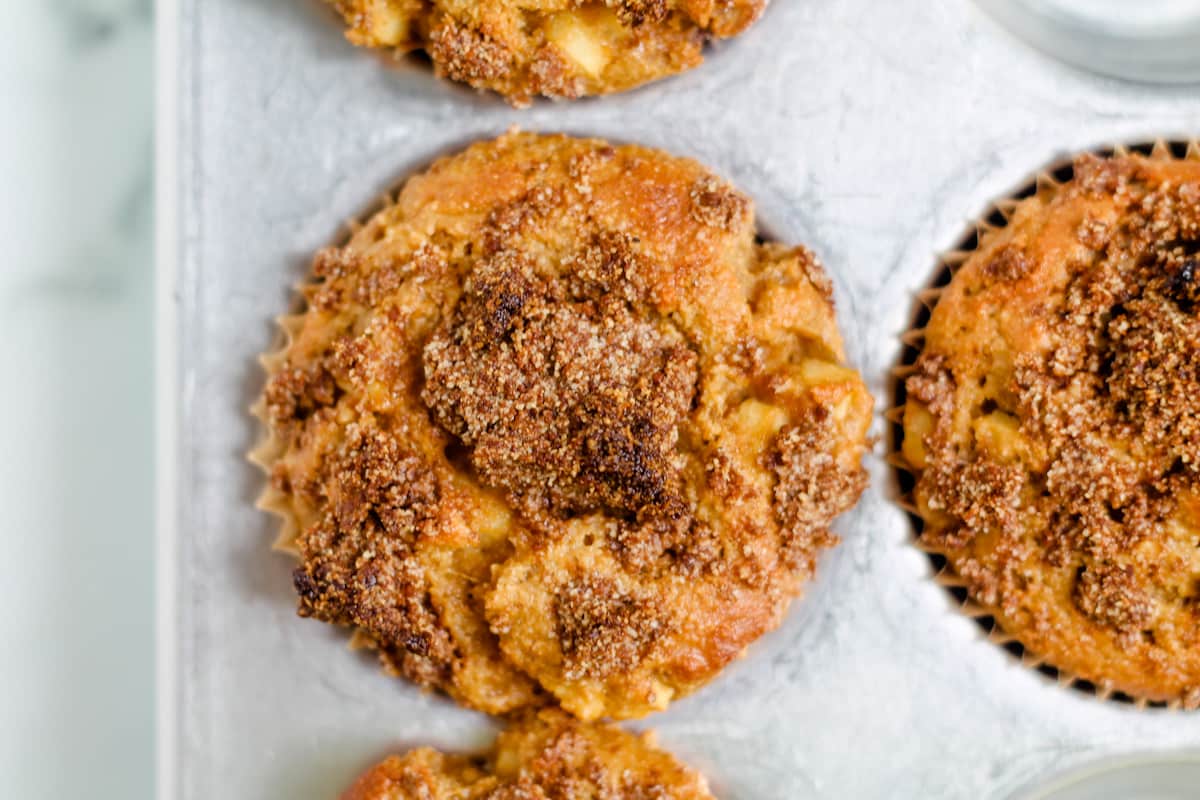 Apple muffins in a muffin tin.