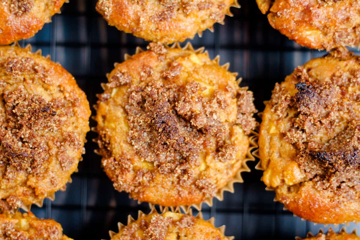 Gluten free apple muffins cooling on a rack.