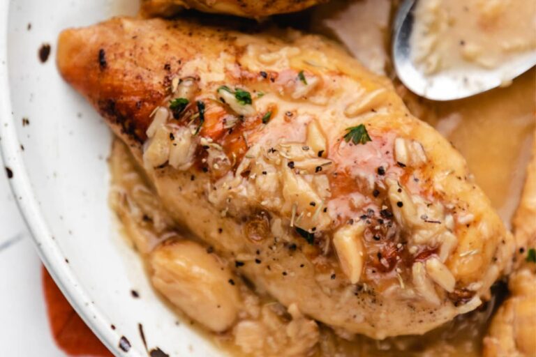 A plate of Instant Pot Creamy Garlic Clove Chicken.