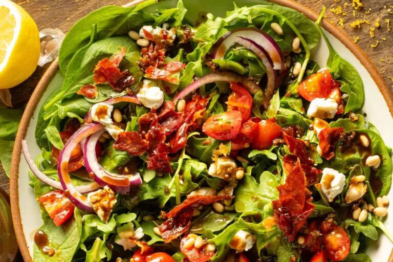 A bowl of Spinach Arugula Salad with Crispy Prosciutto.