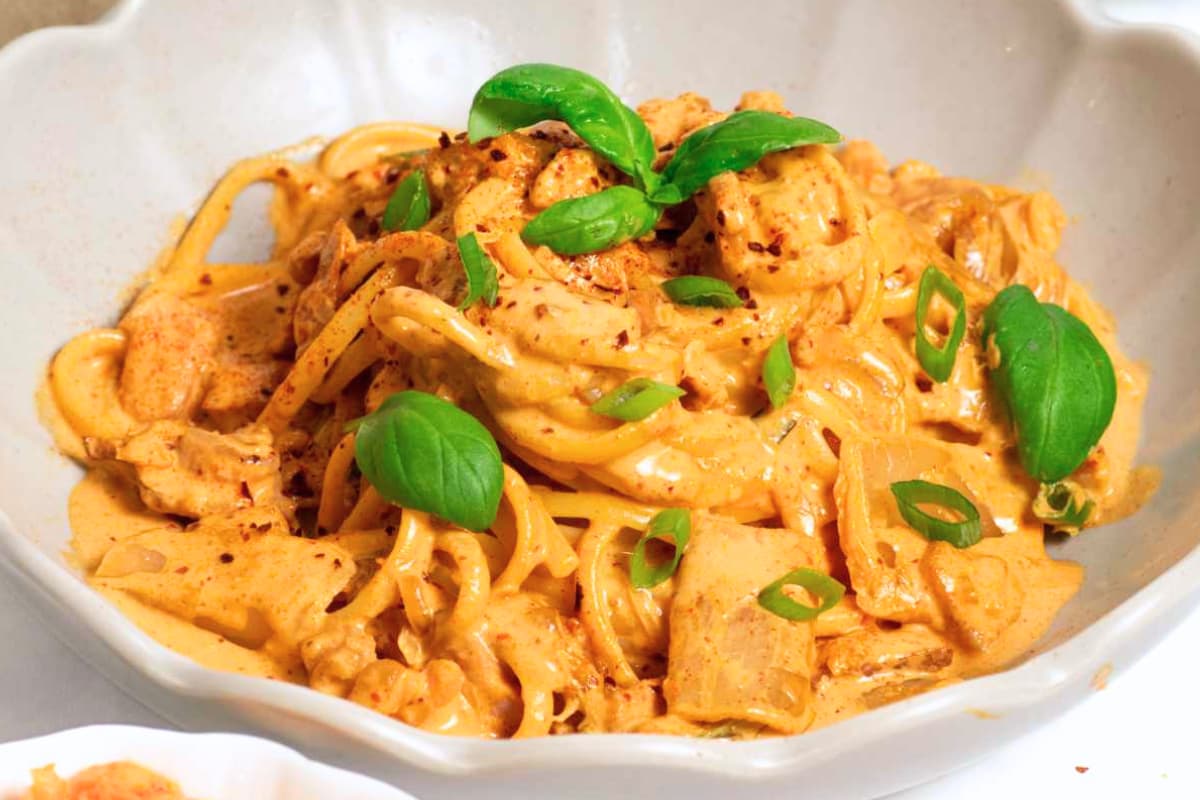 A bowl of 15 Minute Creamy Kimchi Pasta with Bacon.