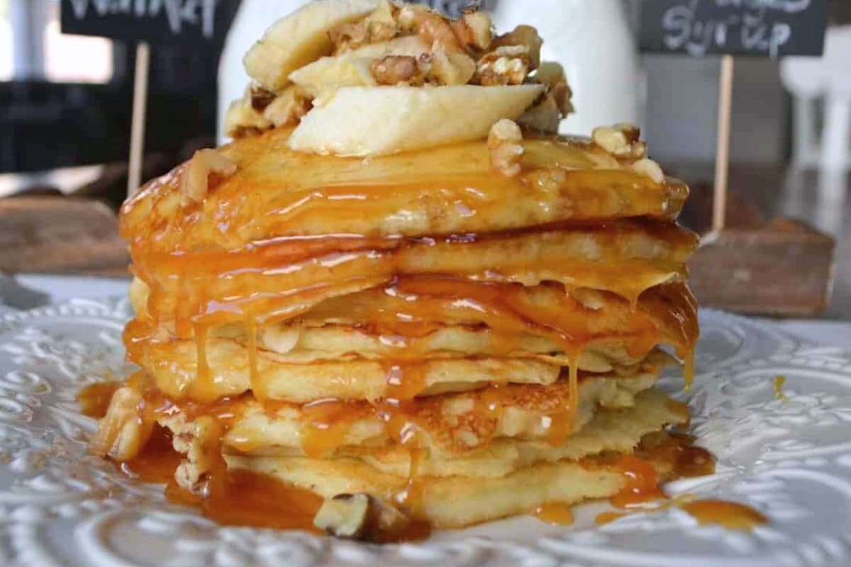 A plate of Goldie’s Banana Walnut Buttermilk Pancakes.