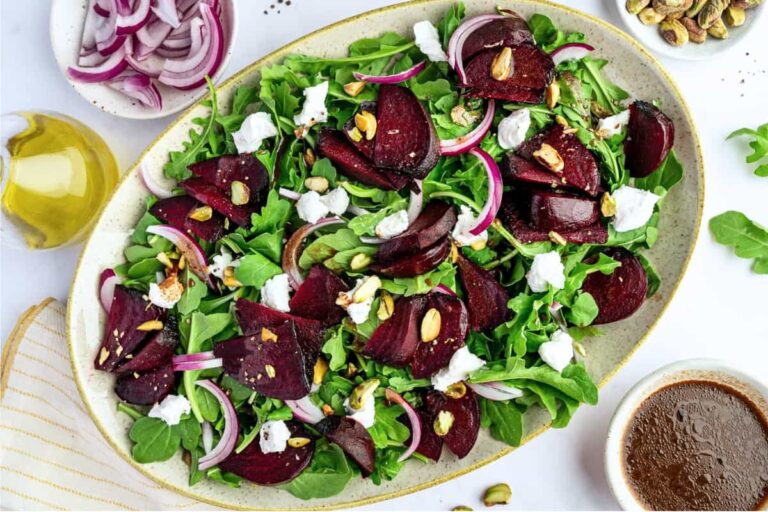 A plate of Beet Salad with Goat Cheese and Arugula.