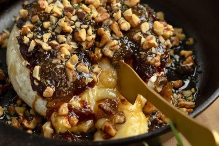 A plate of Fig Jam Baked Brie with Caramelized Onions.