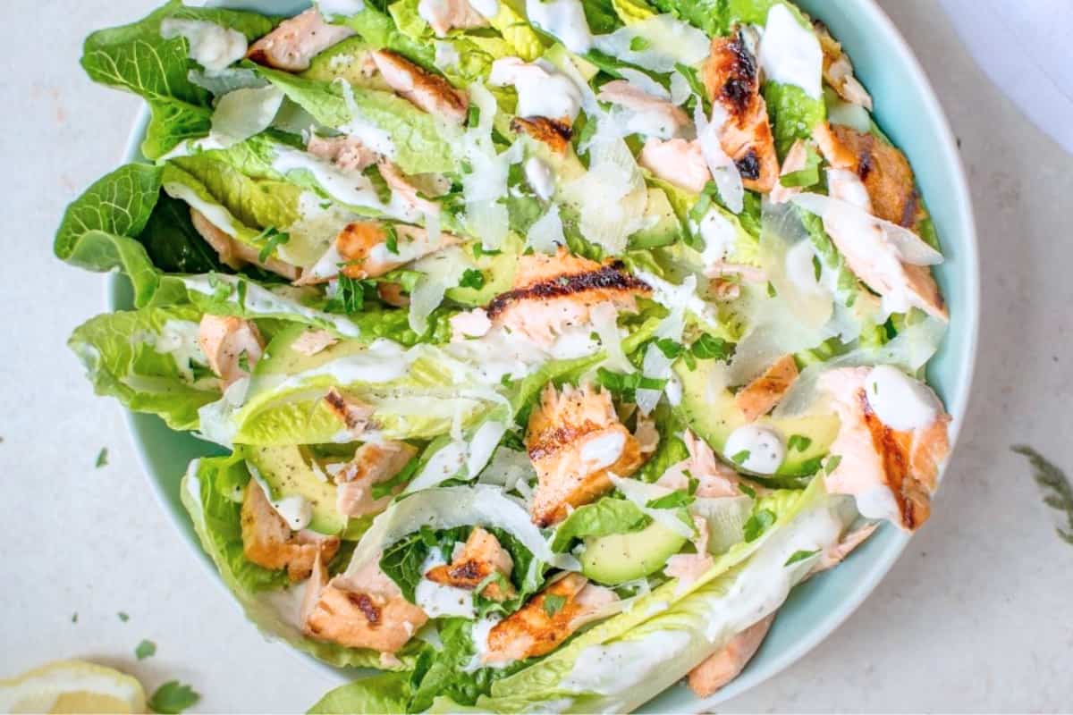 A bowl of Healthy Grilled Salmon Caesar Salad.