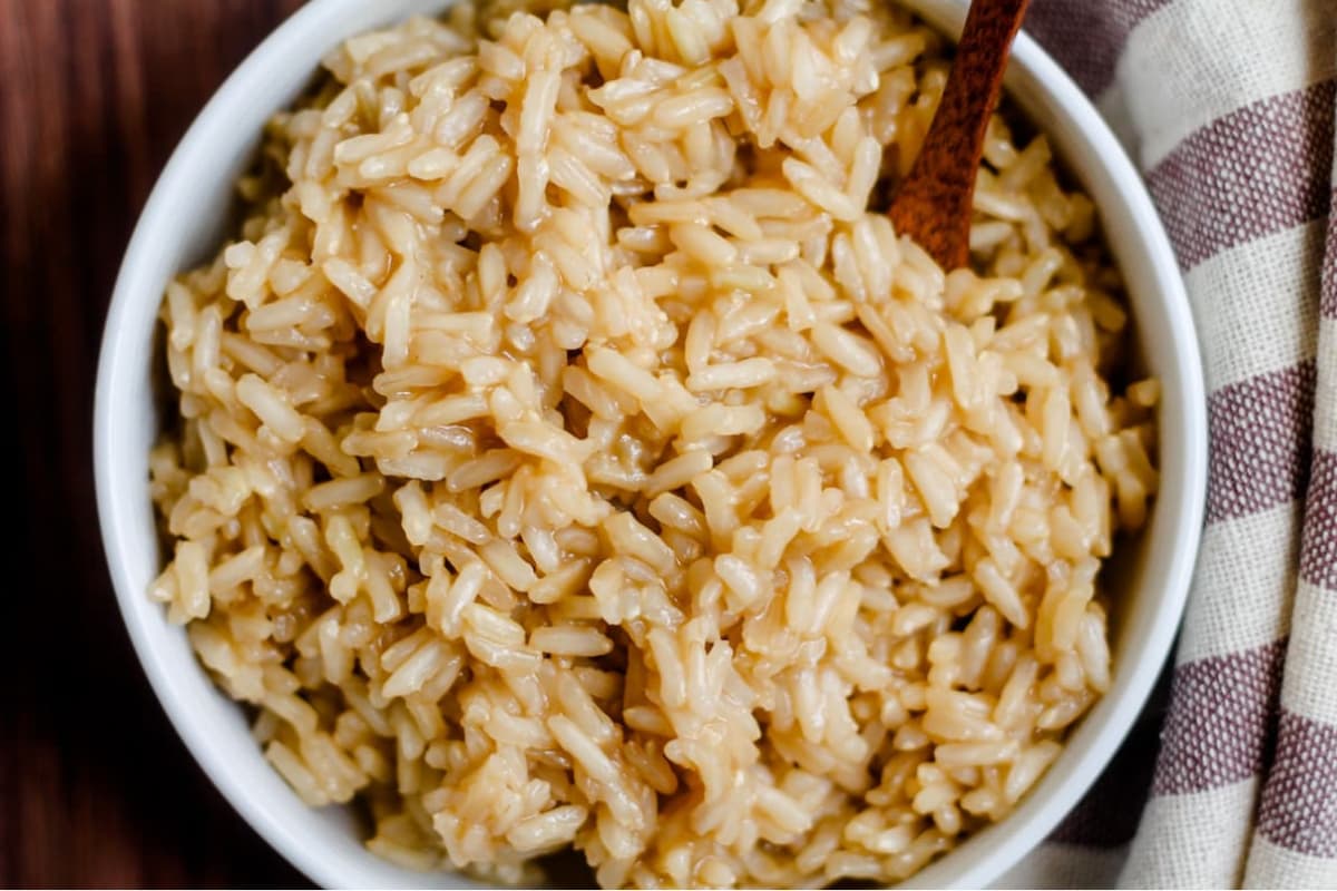 A bowl of brown rice cooked in broth.