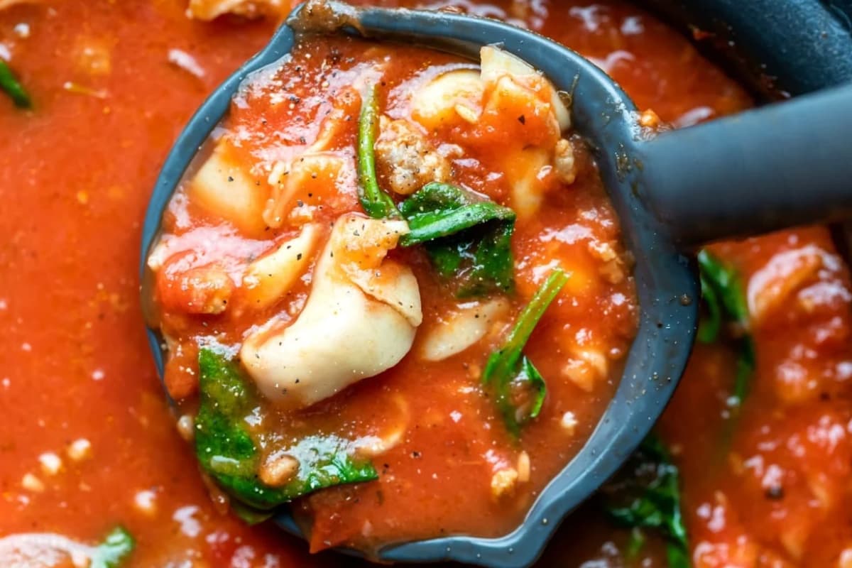 A pot of Slow Cooker Tortellini Soup.