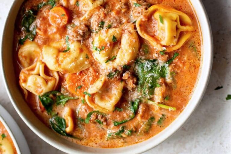 A bowl of Crockpot Tortellini Soup with Sausage.
