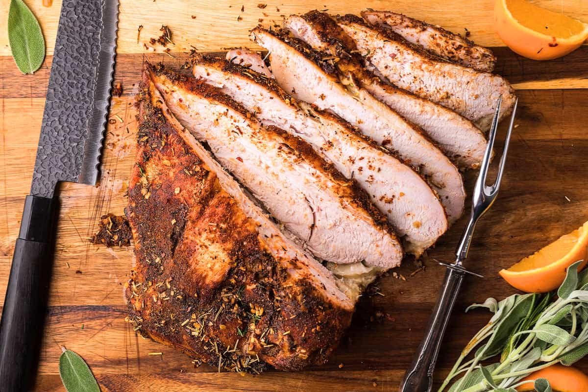 A cutting board of Smoked Turkey Breast.