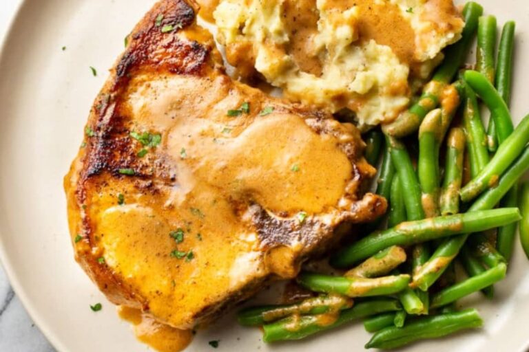 A plate of Smothered Pork Chops and Gravy.
