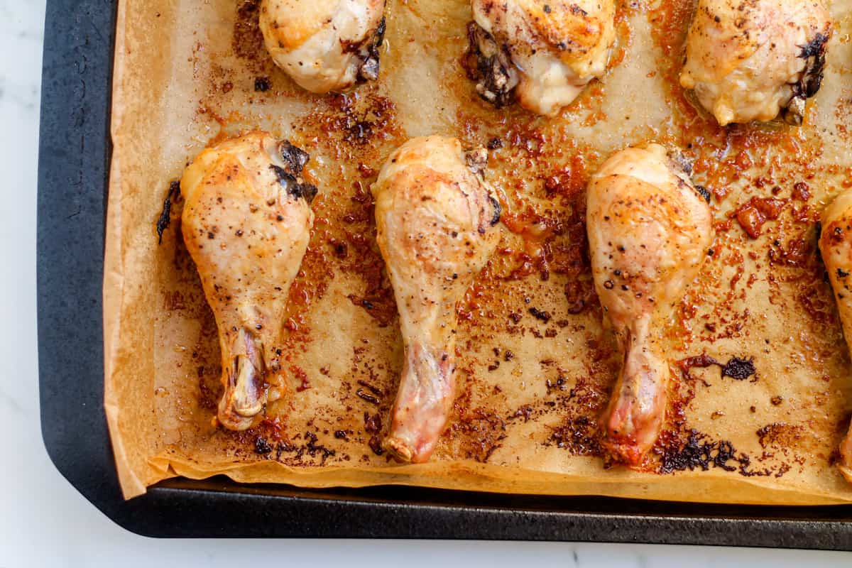 Baked chicken drumsticks out of the oven.