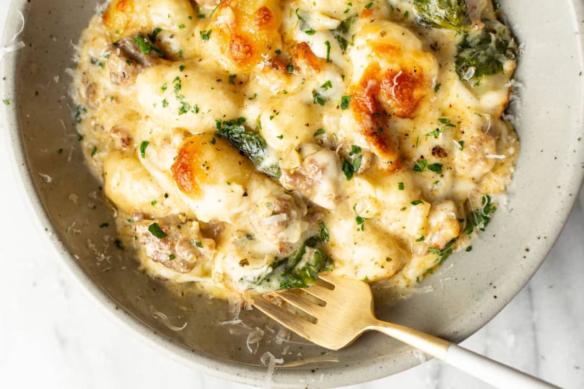 A dish of Pesto Sausage Gnocchi Bake.