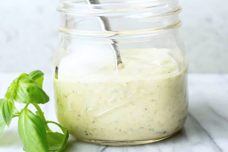 A jar of Creamy Pesto Dressing.