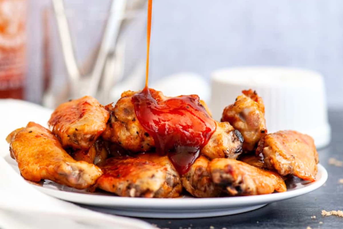 A plate of Sticky Sriracha Wings.