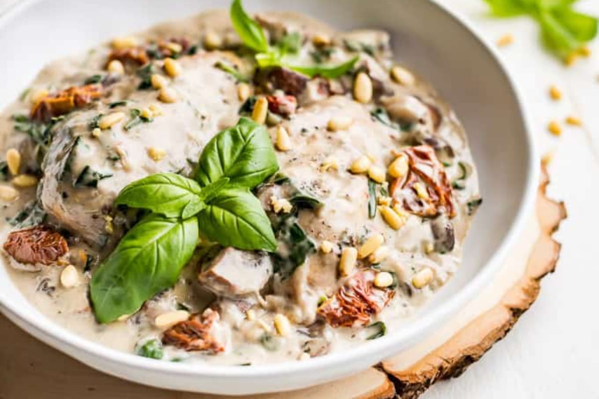 A bowl of Instant Pot Creamy Tuscan Chicken.