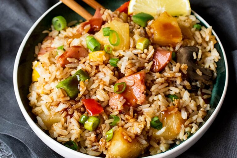 A dish of A bowl of Hawaiian Fried Rice with Sweet and Sour Sauce..