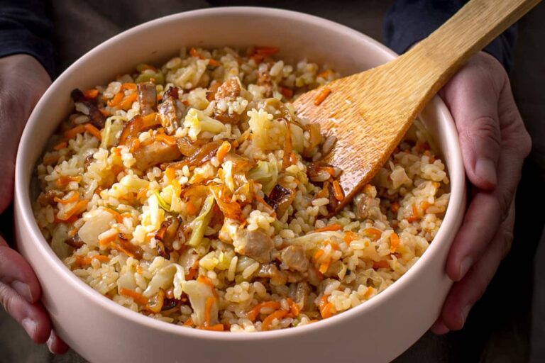 A bowl of One Pot Rice With Pork And Veggies.