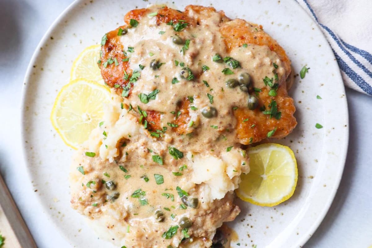 A plate of Creamy Chicken Piccata with Mashed Potatoes.