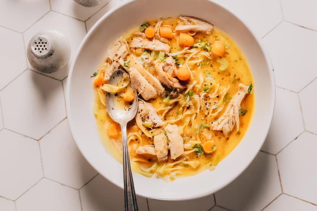 A bowl of Instant Pot Chicken Soup with Egg Noodles.