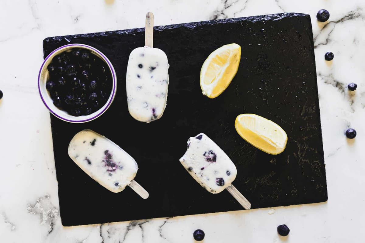 A tray of Blueberry Cottage Cheese Popsicles.