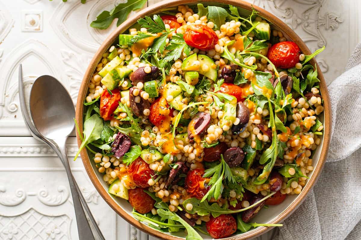 A bowl of Couscous Salad with Cherry Tomato Dressing.