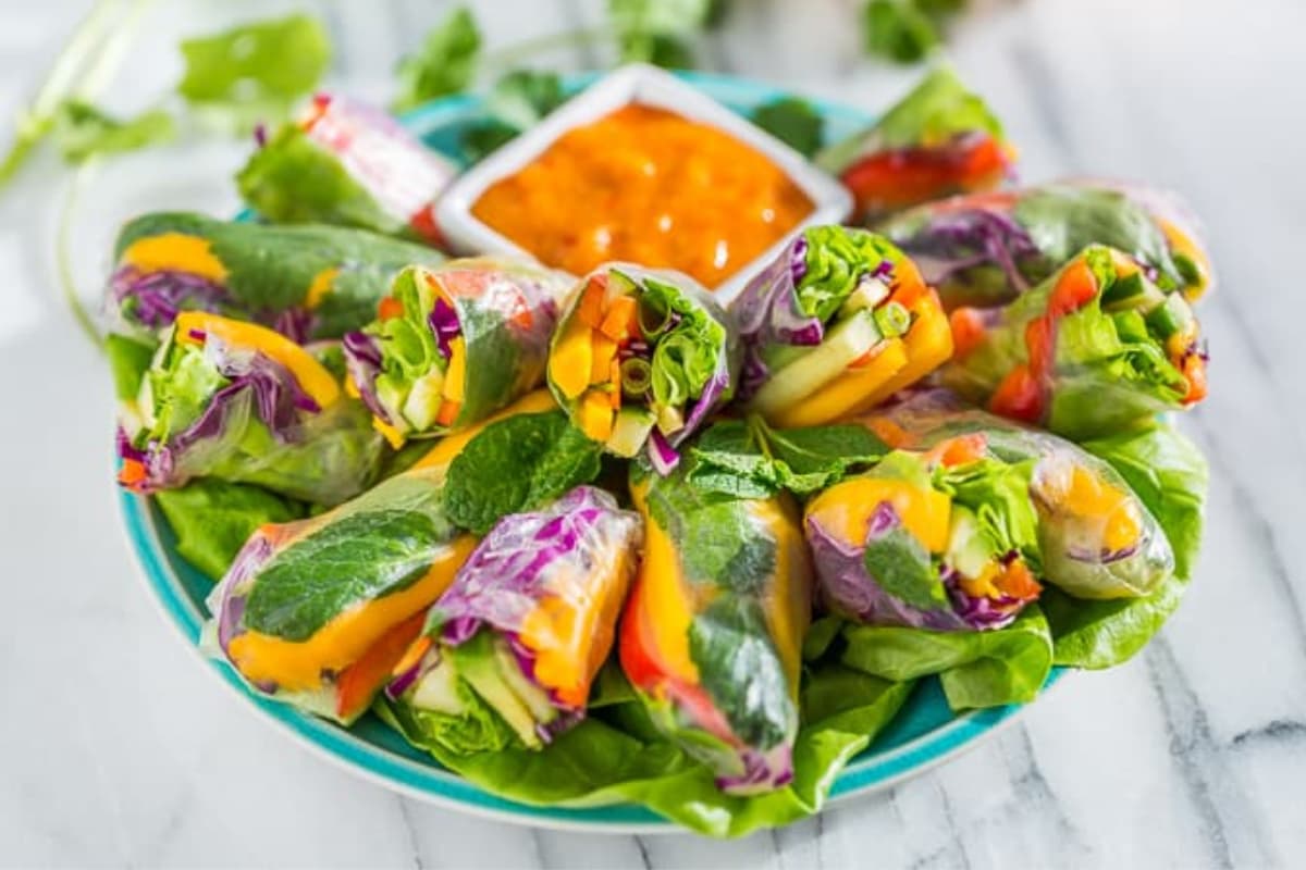A dish of Rainbow Spring Rolls with Sweet Chili Mango Sauce.