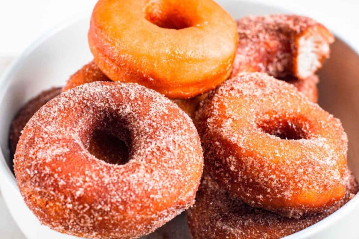 A bowl of Sourdough Doughnuts with Cinnamon Sugar.