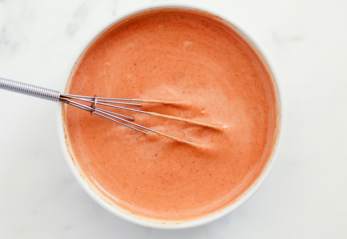 A bowl of ingredients being stirred.