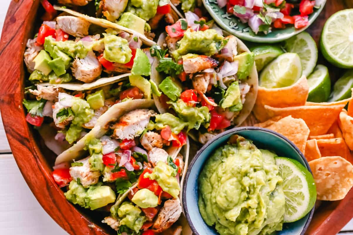 A plate of Grilled Chicken Tacos with Guacamole.