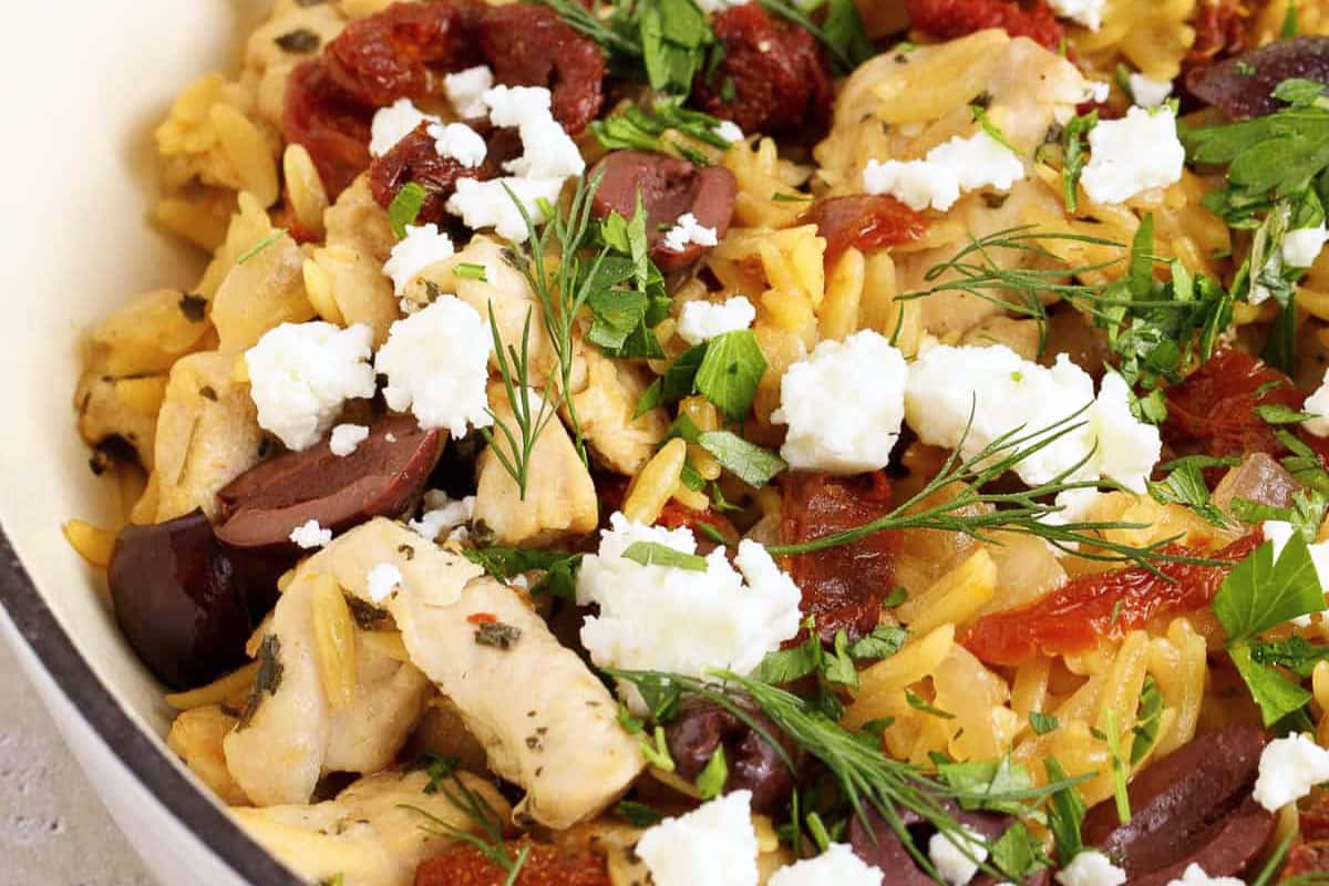A bowl of Easy Mediterranean Chicken and Orzo Skillet.