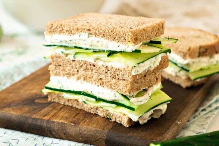 A plate of Classic Cucumber Dill Sandwiches.